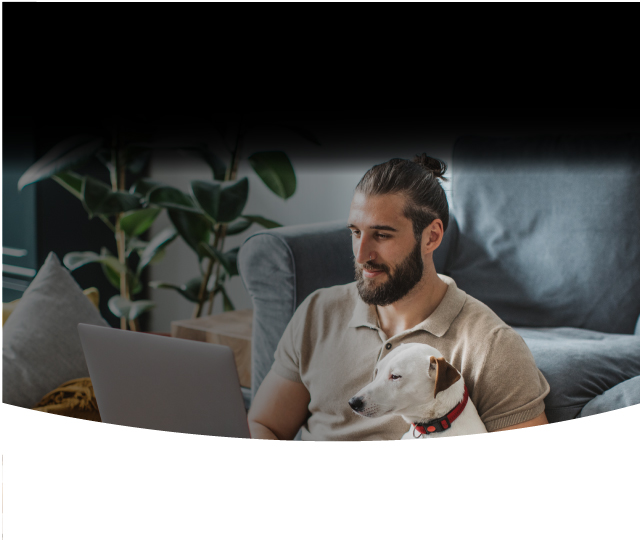 Man on this laptop with his dog